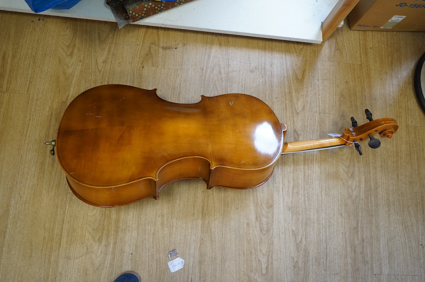 A student’s Golden Strad ‘cello imported by Boosey and Hawkes, body 69.5cm and violin, body 36cm, and a wooden conductors baton. Condition - poor to fair